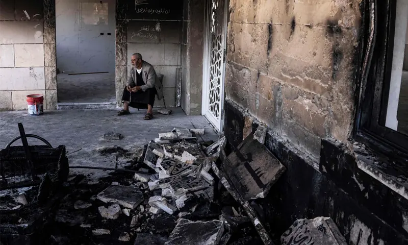 A PALESTINIAN man sits at a mosque burned by Israeli settlers in the village of Qusra, southwest of Nablus.—AFP A PALESTINIAN man sits at a mosque burned by Israeli settlers in the village of Qusra, southwest of Nablus.—AFP