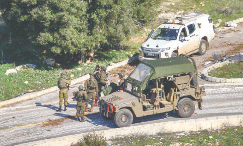 Israeli soldiers patrol the entrance of a village along the border with Lebanon. — AFP/File Israeli soldiers patrol the entrance of a village along the border with Lebanon. — AFP/File