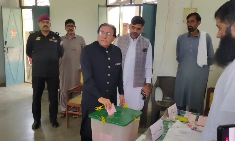 AJK Chief Justice Raja Saeed Akram Khan casts his ballot at a polling station in Bhimber’s Samahni tehsil. — photo via Tariq Naqash