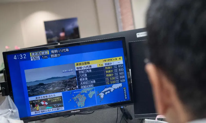 Reporters watch the news showing a large quake and possible one meter tsunami wave in Southern Japan, from an office in Tokyo on July 28, 2026. &mdash; AFP