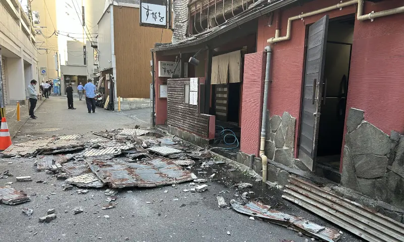 The exterior wall of a shop is seen collapsed in an earthquake, in Kumamoto City on July 28, 2026. — AFP