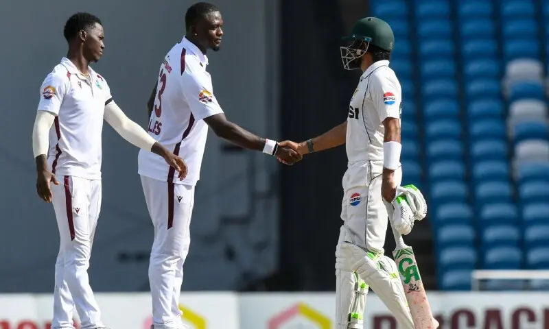 Babar Azam (R) congratulates bowler Jayden Seales (C) and Shamar Joseph of West Indies for their 90-run victory during the fourth day of the first Test cricket match between West Indies and Pakistan at the Brian Lara Cricket Academy in Tarouba, Trinidad and Tobago, on July 28, 2026. &mdash; AFP