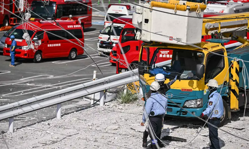 Workers gather outside the damaged Aeon Mall Kumamoto in Kashima, Kumamoto Prefecture, on July 29, 2026, after an earthquake struck southwestern Japan the previous day. — AFP