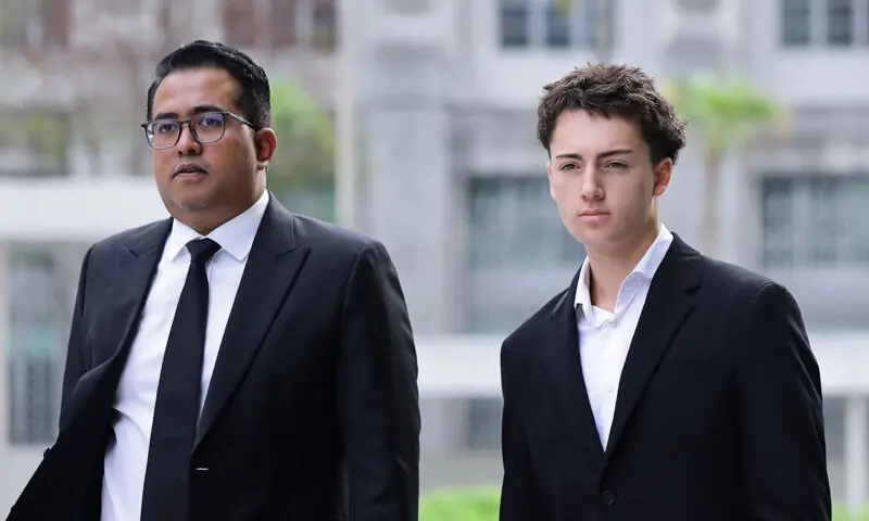 French teenager Didier Gaspard Owen Maximilien and his lawyer arrive at the State Courts in Singapore.&mdash;AFP