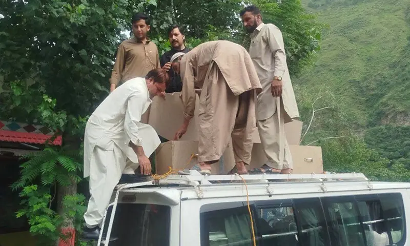 SHANGLA: Locals offload coffins of labourers who lost their lives in the Quetta coal mine tragedy.—Dawn SHANGLA: Locals offload coffins of labourers who lost their lives in the Quetta coal mine tragedy.—Dawn