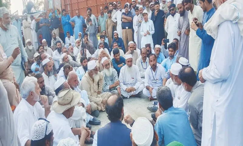 Protesters stage a sit-in on the road after being stopped from going to Tarbela Dam powerhouse. — Dawn/File Protesters stage a sit-in on the road after being stopped from going to Tarbela Dam powerhouse. — Dawn/File
