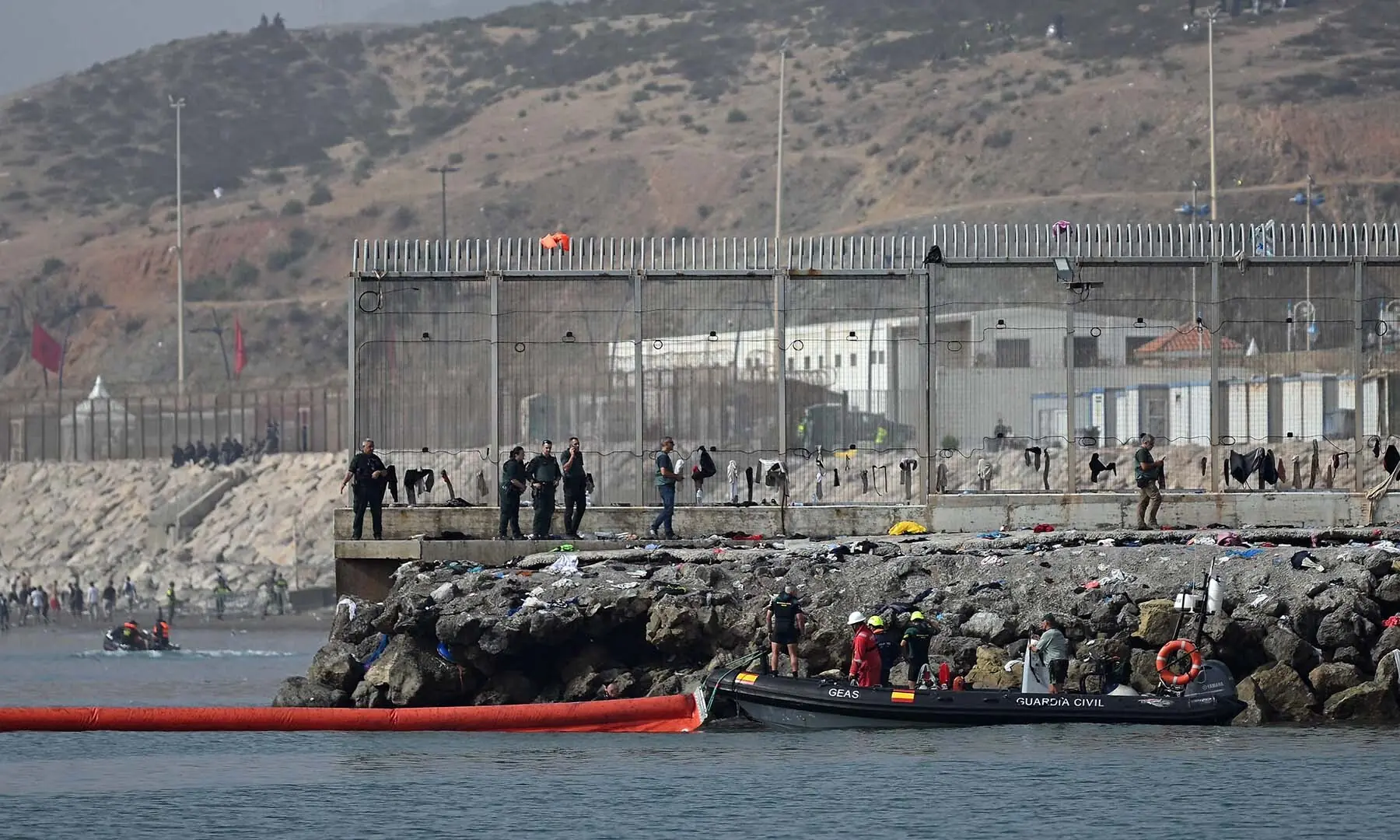 A 500-metre-long pneumatic barrier is deployed in the water by a Spanish Guardia Civil boat near the border post to reinforce security following illegal crossings from Morocco into the Spanish enclave of Ceuta, on August 1, 2026. — AFP