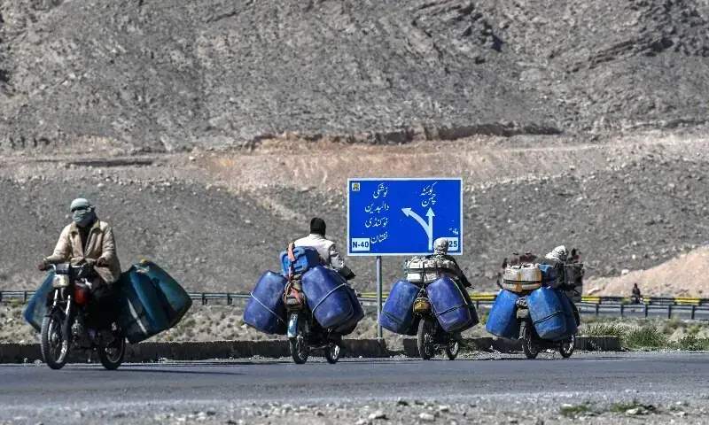 This photograph taken on March 14, 2026 shows vendors transporting jerrycans filled with smuggled Iranian petrol on their motorcycles, on the outskirts of Quetta. — AFP/File This photograph taken on March 14, 2026 shows vendors transporting jerrycans filled with smuggled Iranian petrol on their motorcycles, on the outskirts of Quetta. — AFP/File
