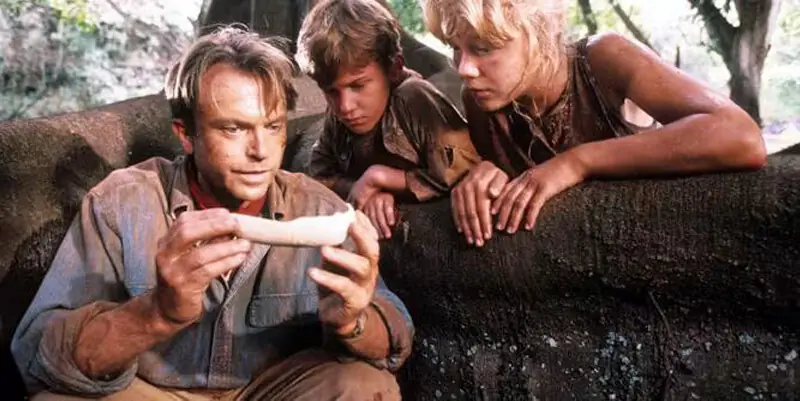 Sam Neill as paleontologist Dr Alan Grant alongside child artists Joseph Mazzello and Ariana Richards in Jurassic Park (1993) | Universal Studios Sam Neill as paleontologist Dr Alan Grant alongside child artists Joseph Mazzello and Ariana Richards in Jurassic Park (1993) | Universal Studios