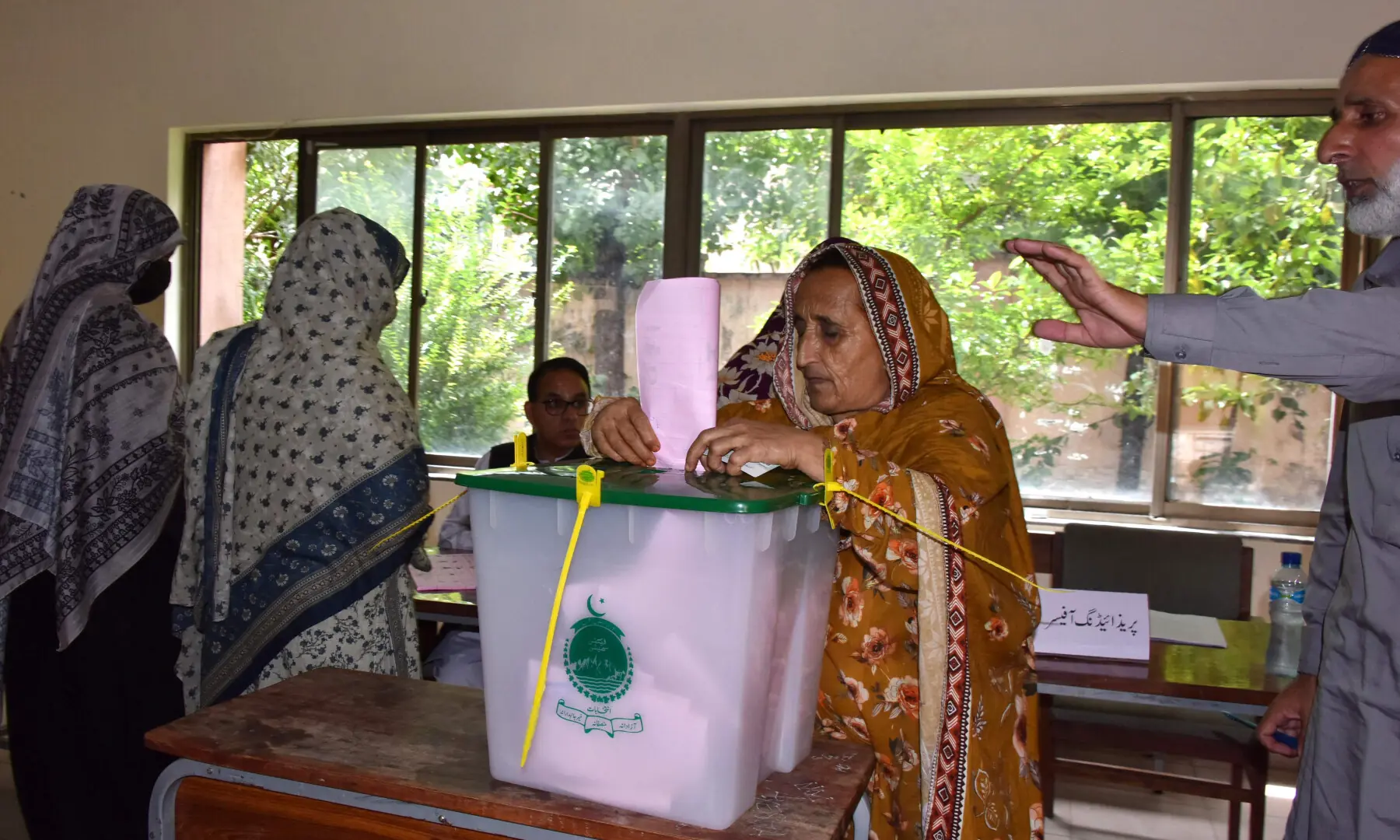 A woman casts her ballot at a polling station during the second phase of elections for the local legislative assembly in Muzaffarabad, AJK, on Aug 2, 2026. &mdash; AFP