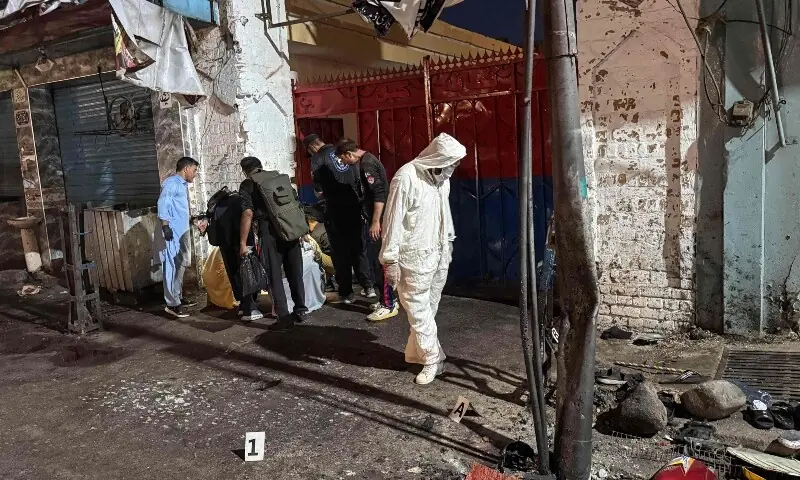 Police officials inspect the site following a suicide bombing during a protest in Swat district on August 2. — AFP Police officials inspect the site following a suicide bombing during a protest in Swat district on August 2. — AFP