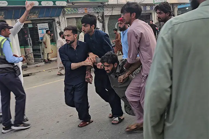 PEOPLE evacuate an injured victim following a suicide bombing during a protest.—AFP PEOPLE evacuate an injured victim following a suicide bombing during a protest.—AFP