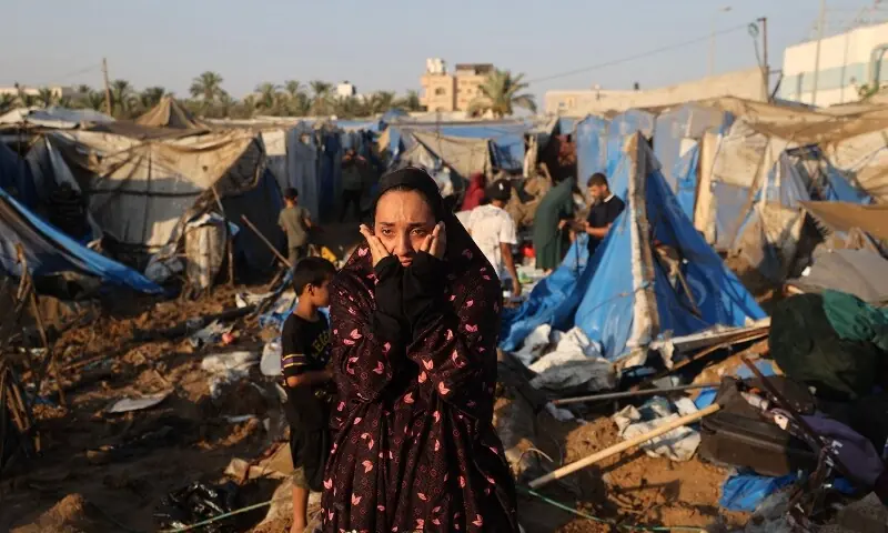 A displaced Palestinian woman reacts as she looks at the destruction of tent shelters following an Israeli airstrike that targeted a nearby medical supplies and pharmaceuticals warehouse belonging to Al-Aqsa Martyrs Hospital, in Deir el-Balah, central Gaza Strip, on August 1, 2026. &mdash;AFP/File