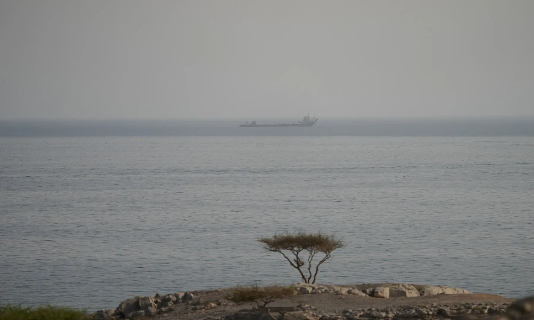 A large vessel transits the Strait of Hormuz, as seen from Musandam, Oman, on August 3, 2026. &mdash; Reuters