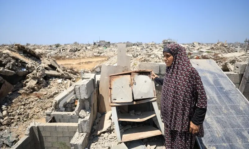 Displaced Palestinian woman Soumah Dawla looks on as she stands on the rooftop of a house where she has taken shelter after being displaced due to the further advancement of the Israeli military’s ‘Yellow Line’, in Gaza City on August 1, 2026. — Reuters