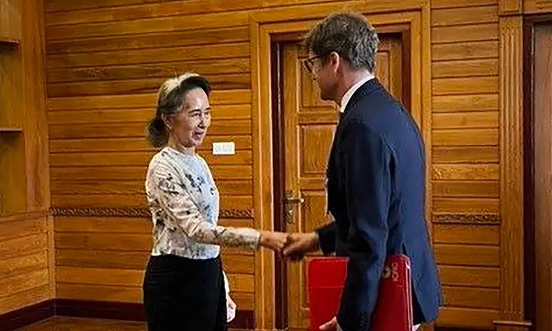 This handout photo taken and released on August 3, 2026 by Myanmar's Presidential Press and Information Bureau (PPIB) shows detained former civilian leader Aung San Suu Kyi (L) meeting with Arnaude de Baecque, resident representative of the International Committee of the Red Cross (ICRC) to Myanmar, in Naypyidaw. &mdash; via AFP