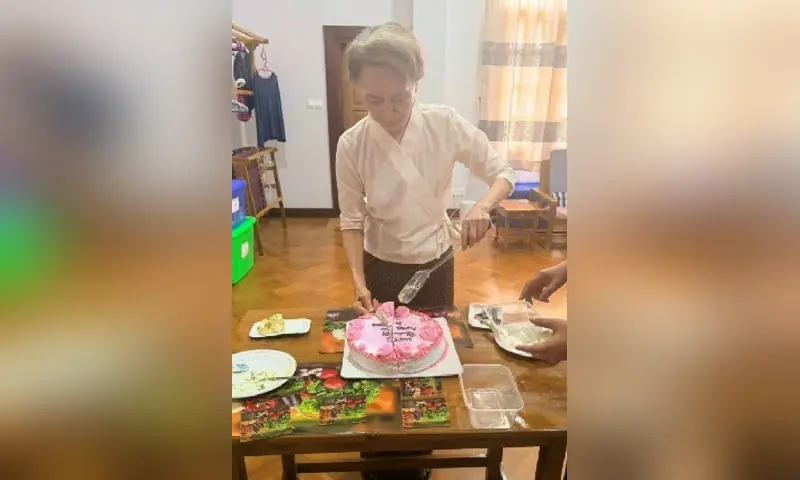 This undated handout photo released on August 3, 2026 by Myanmar&rsquo;s Presidential Press and Information Bureau (PPIB) shows detained former civilian leader Aung San Suu Kyi cutting a cake in Naypyidaw. &mdash; via AFP
