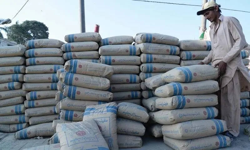 A worker can be seen with bags of cement. — AFP/File A worker can be seen with bags of cement. — AFP/File