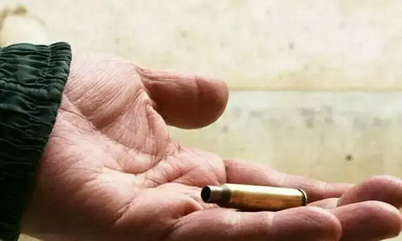 Image shows a person holding a bullet. &mdash; AFP/File