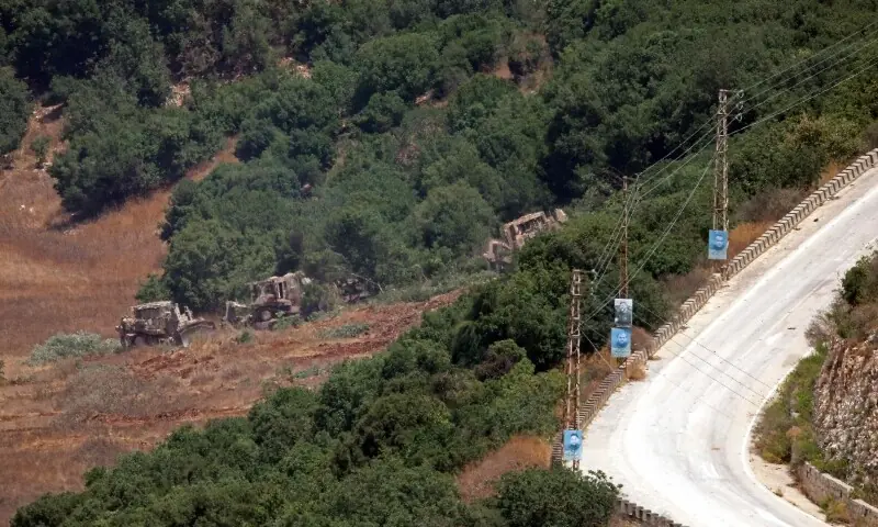This photograph taken from the southern Lebanese village of Chaqra shows Israeli military D9 armoured bulldozers carrying out land-clearing operations in a wooded area near the entrance to the village of Houla, in the Wadi al-Slouqi area on August 4, 2026. &mdash;Reuters