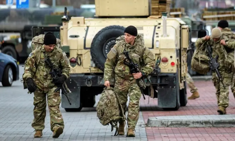 US soldiers from the 82nd Airborne Division walk near the G2A Arena following their arrival at Rzeszow-Jasionka Airport, in Jasionka, Poland February 8, 2022. &mdash; Reuters