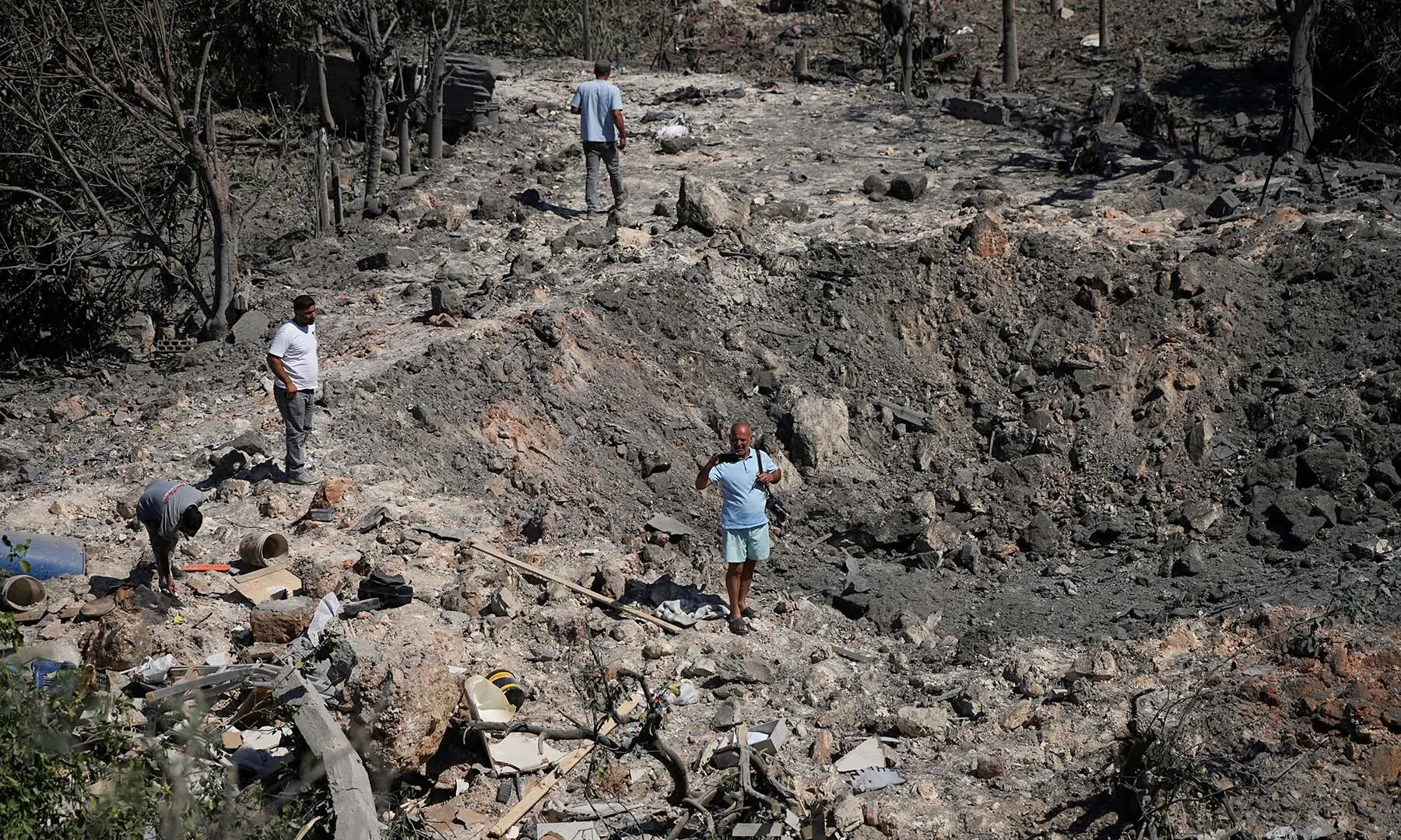 People and journalists stand at a site hit by Israeli strikes that occurred in the early hours of Thursday, according to Lebanon&rsquo;s state news agency NNA, in Burj al-Shamali, southern Lebanon on August 6, 2026. &mdash; Reuters