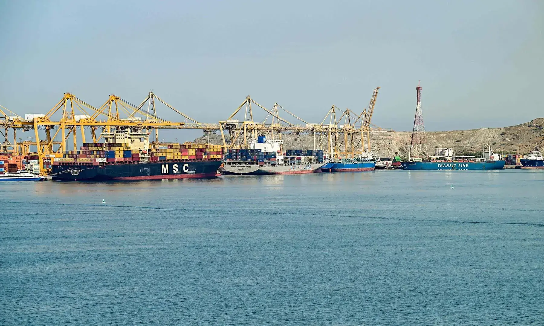 (L to R) The Liberia-flagged container vessel MSC Tasman VI, the Singapore-flagged container vessel Wan Hai 353, and other ships are docked along a pier at the Khor Fakkan Container Terminal, the only natural deep-sea port in the region and one of the major container ports in Sharjah Emirate, along the Gulf of Oman on June 19, 2026. &mdash; AFP