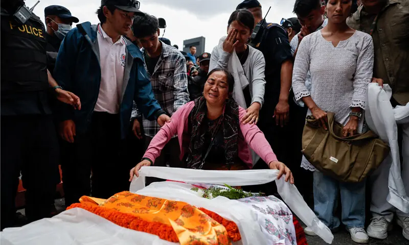 Kathmandu: Marni Gurung, the sister of mountaineer Purna Bahadur Gurung &mdash; who died in an avalanche while summiting Broad Peak &mdash; places a ceremonial scarf on the coffin containing his body at Nepal&rsquo;s Tribhuvan International Airport.&mdash;Reuters