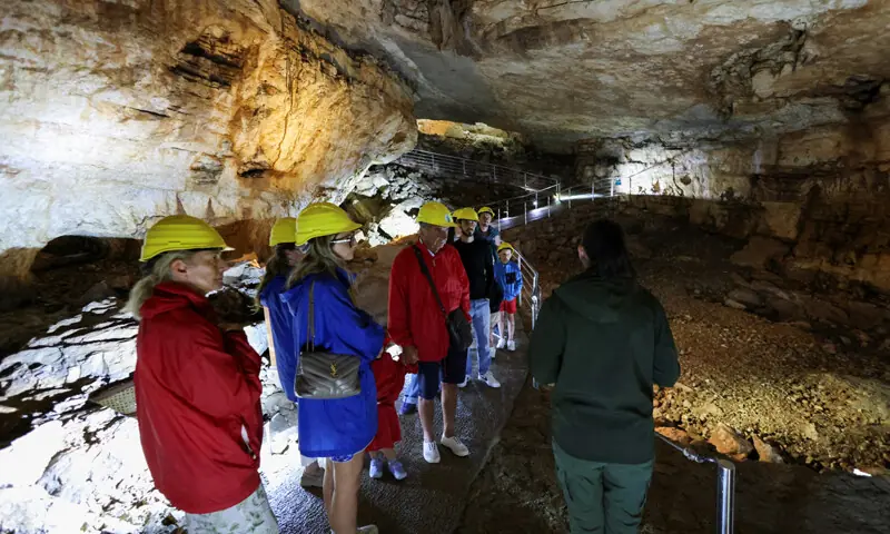 TOURISTS visit Vjetrenica cave, where temperatures remain a constant 11 degrees Celsius.—Reuters TOURISTS visit Vjetrenica cave, where temperatures remain a constant 11 degrees Celsius.—Reuters
