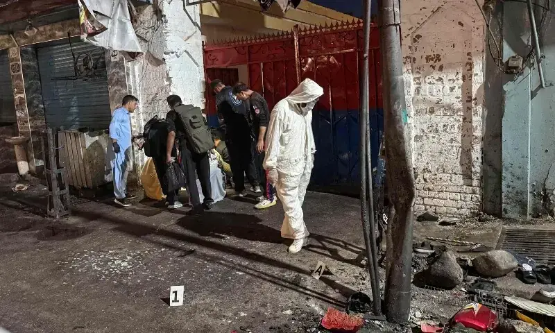 Police officials inspect the site following a suicide bombing during a protest in Swat district on August 2. &mdash; AFP/File