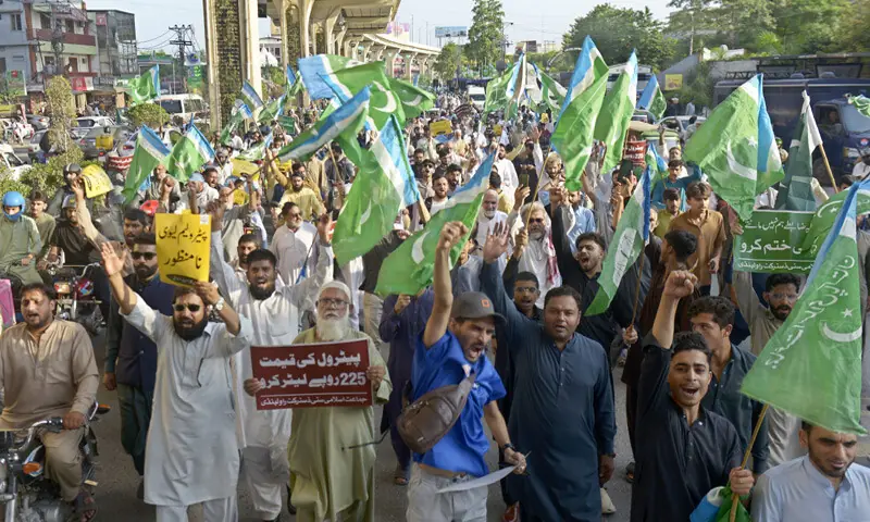 Activists of Jamaat-i-Islami hold a protest on Murree Road in Rawalpindi against inflation and the petroleum levy on Friday. &mdash; Photo by Mohammad Asim