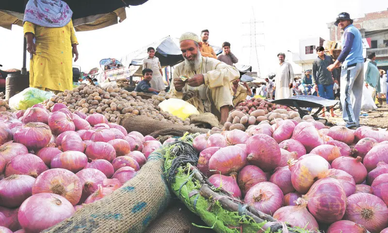 A man sells onions in a market in Gujranwala.—Shutterstock A man sells onions in a market in Gujranwala.—Shutterstock
