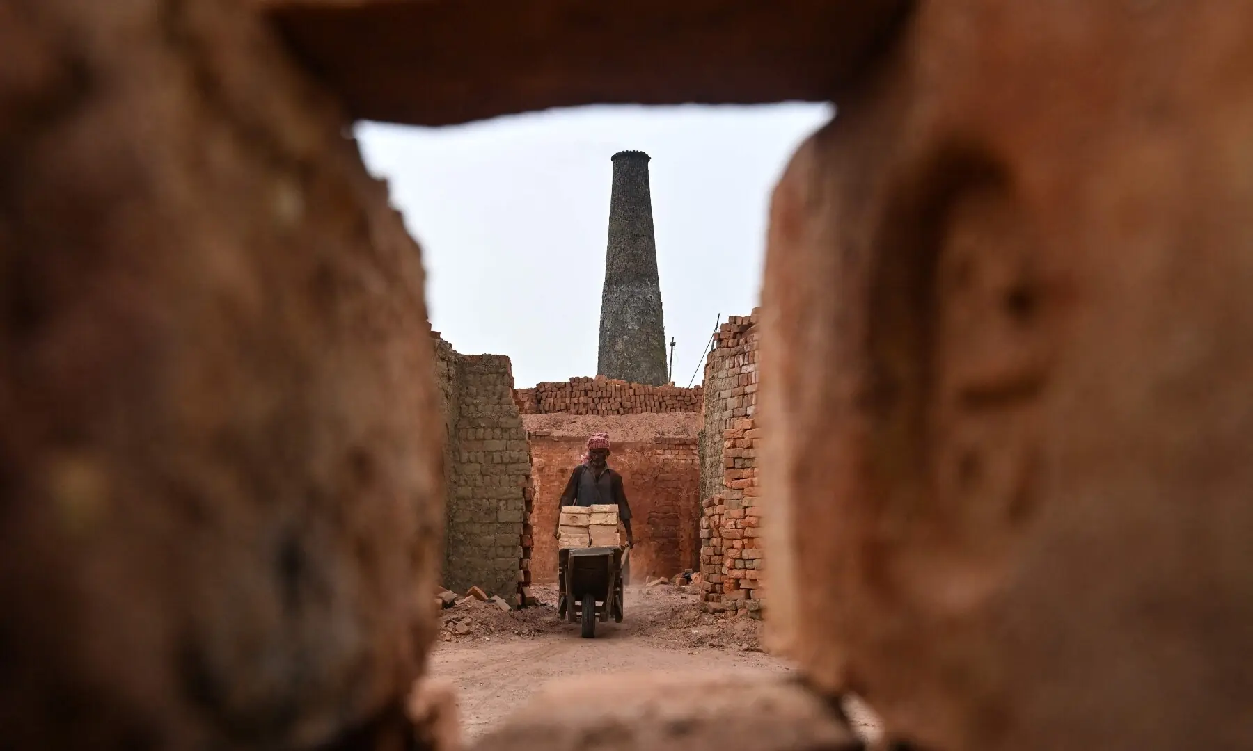 A worker pushes a wheelbarrow at a brick kiln in Sheikhupura, in Punjab on July 20, 2026. —AFP A worker pushes a wheelbarrow at a brick kiln in Sheikhupura, in Punjab on July 20, 2026. —AFP