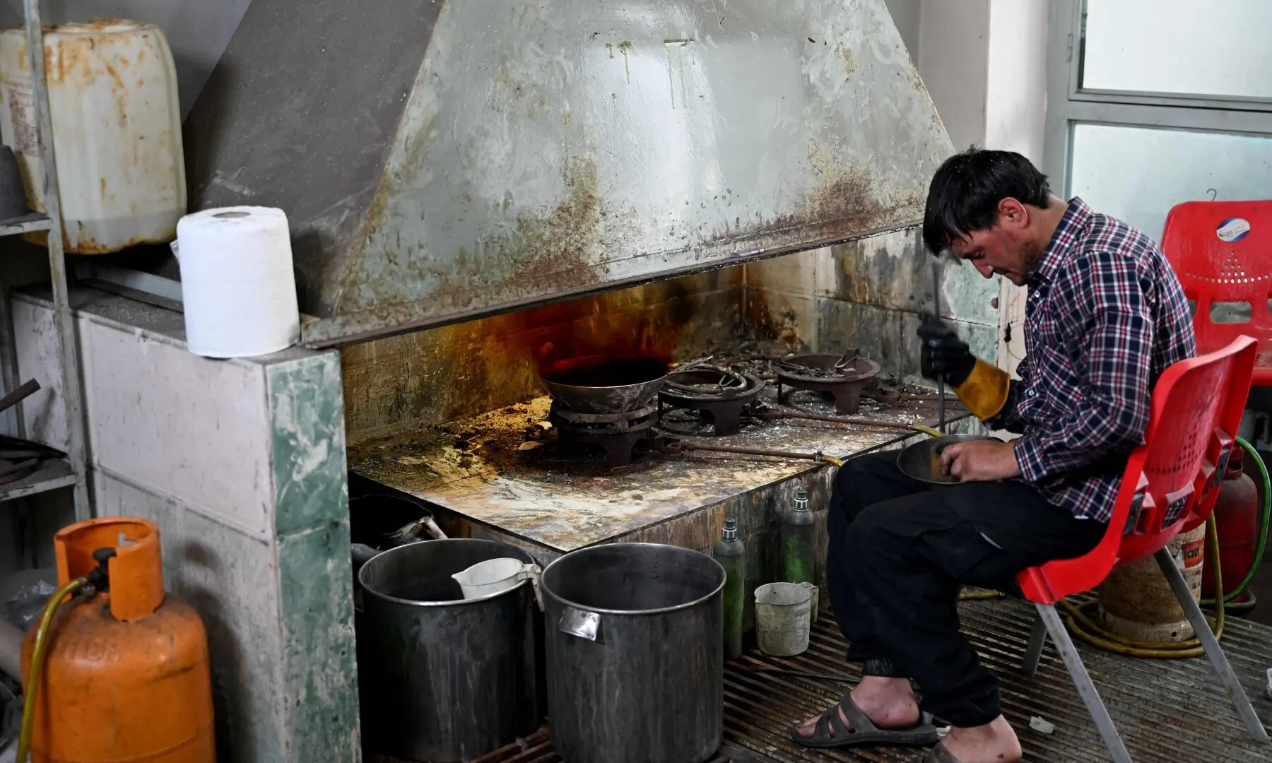 This photograph taken on August 5, 2026 shows an Afghan goldsmith melting gold at a workshop in Fayzabad, in Afghanistan&rsquo;s northeastern Badakhshan province. &mdash; AFP