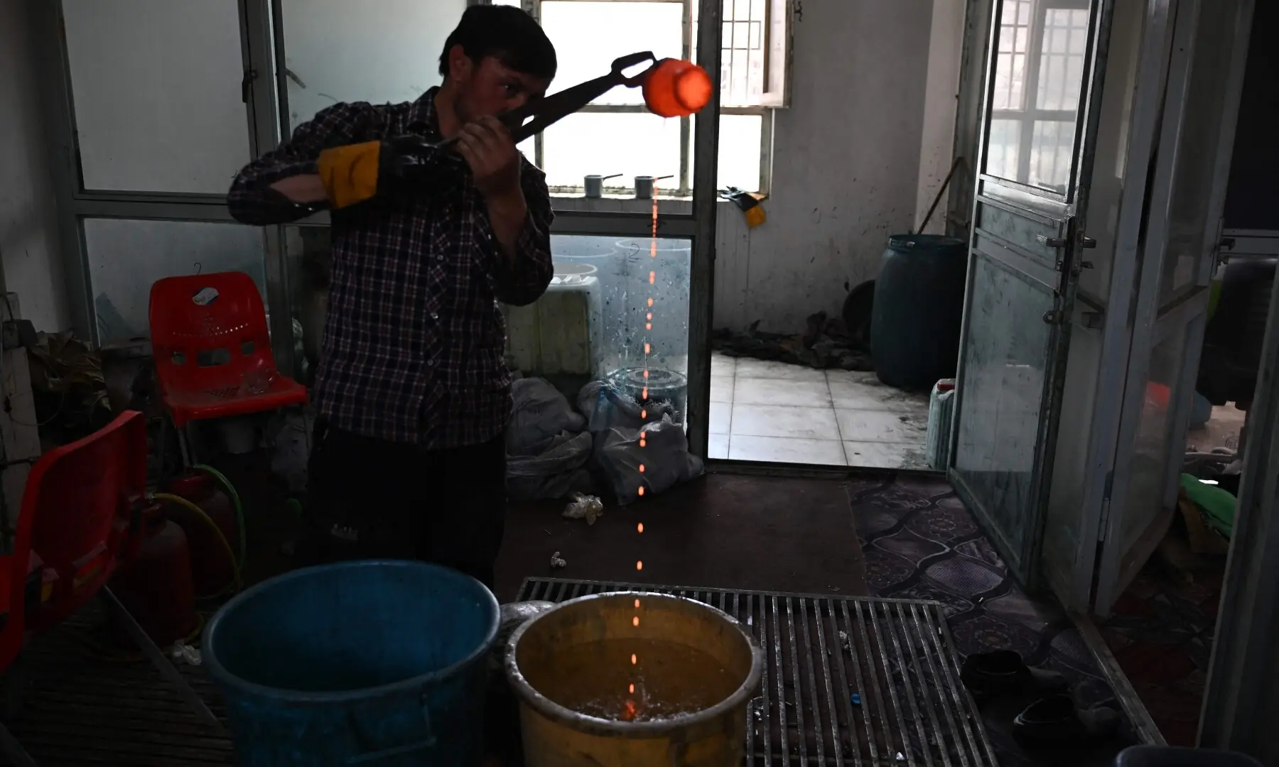 This photograph taken on August 5, 2026 shows an Afghan goldsmith melting gold at a workshop in Fayzabad, in Afghanistan&rsquo;s northeastern Badakhshan province. &mdash; AFP