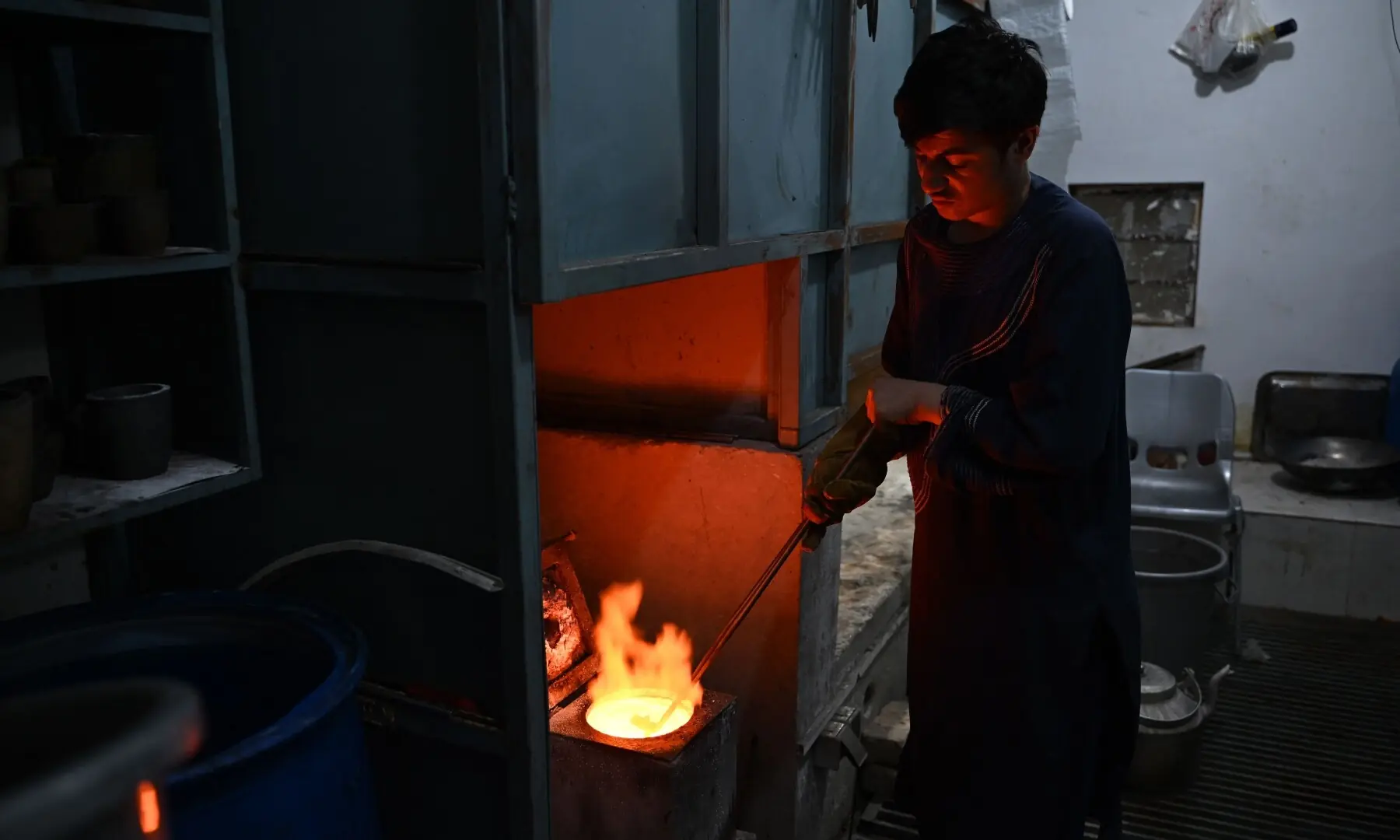 This photograph taken on August 4, 2026 shows an Afghan goldsmith melting gold at a workshop in Fayzabad, in Afghanistan&rsquo;s northeastern Badakhshan province. &mdash; AFP