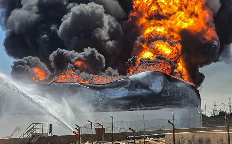 FIREFIGHTERS spray water as black smoke and flames rise from a storage tank at a refinery in Libya.—Reuters FIREFIGHTERS spray water as black smoke and flames rise from a storage tank at a refinery in Libya.—Reuters