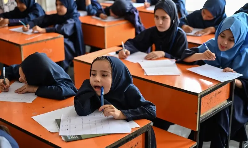 This photograph taken on July 21, 2026 shows Afghan girls taking their midterm exams at a primary school in Kabul. &mdash; AFP