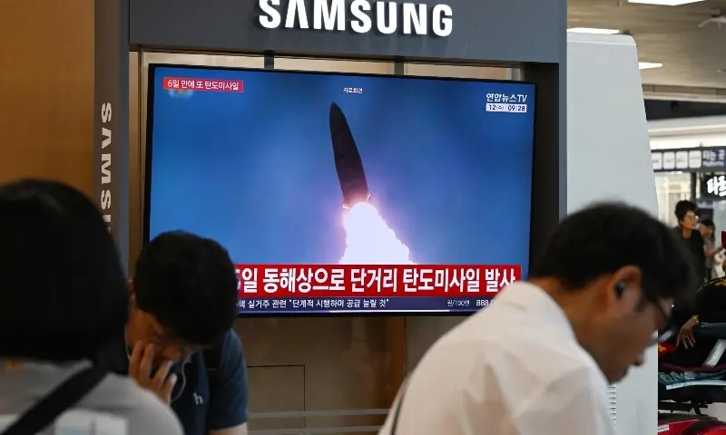News coverage showing file footage of a North Korean missile launch is seen on a screen at Seoul Station in Seoul on August 12, 2026. &mdash; AFP