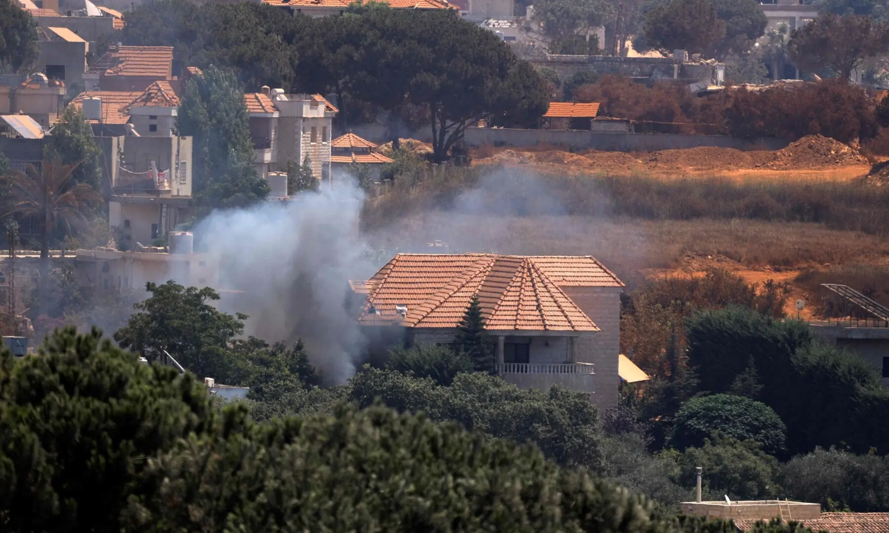 This picture taken from the southern Lebanese village of Zawtar al-Gharbiyah shows smoke billowing from a house in the Israeli-controlled nearby village of Zawtar al-Charkiyah on August 13, 2026. &mdash; AFP
