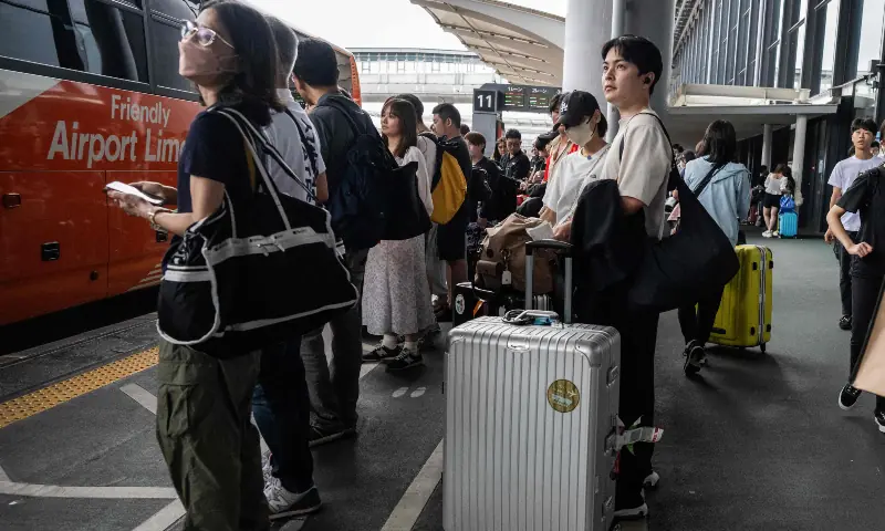 Passengers wait to board a bus at the Narita International Airport in Narita, Chiba prefecture on August 14, 2026, after many of the train lines to the airport were closed. — AFP Passengers wait to board a bus at the Narita International Airport in Narita, Chiba prefecture on August 14, 2026, after many of the train lines to the airport were closed. — AFP