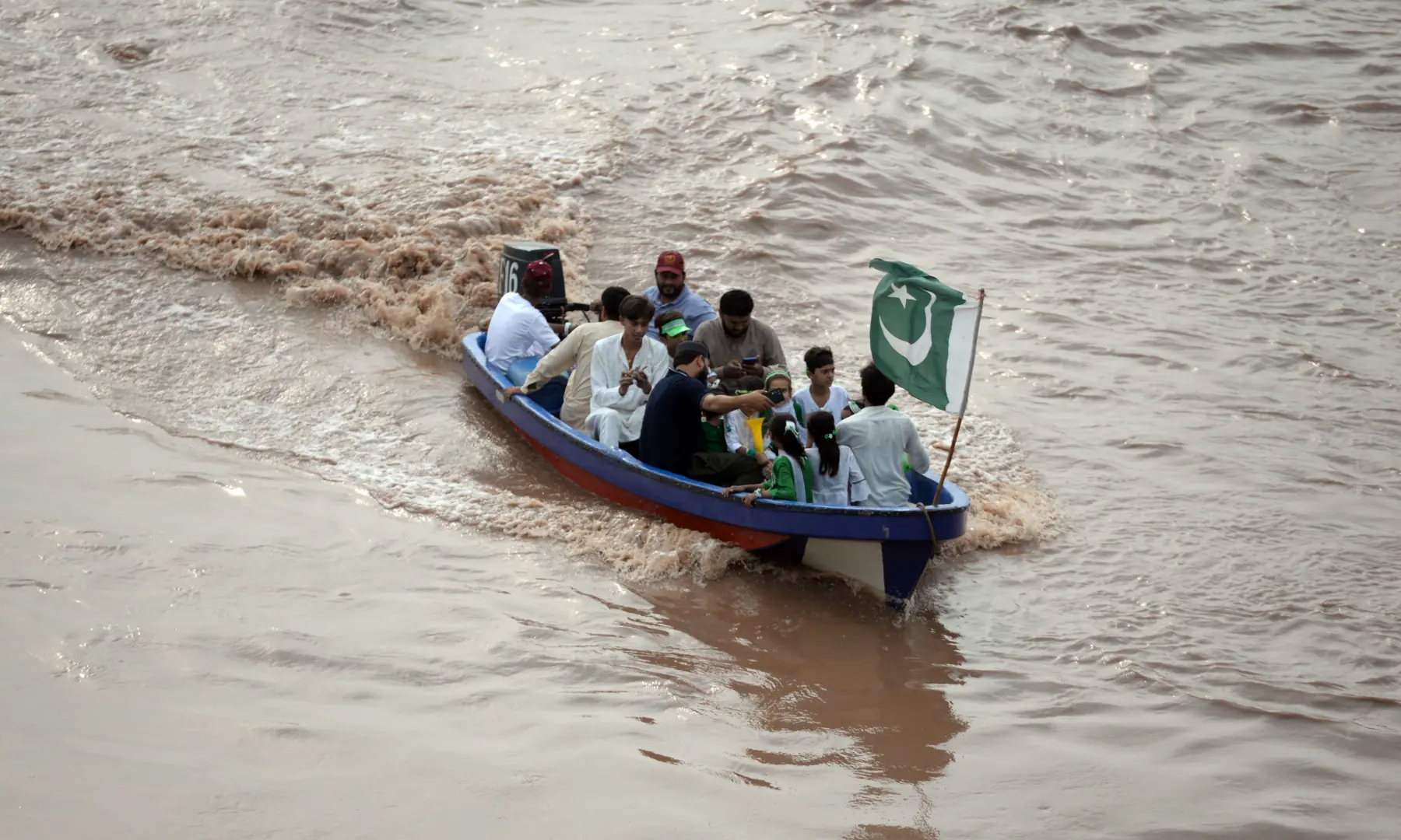 A Pakistan flag is seen flying from a small boat on the River Ravi on Aug 14, 2026. — White Star