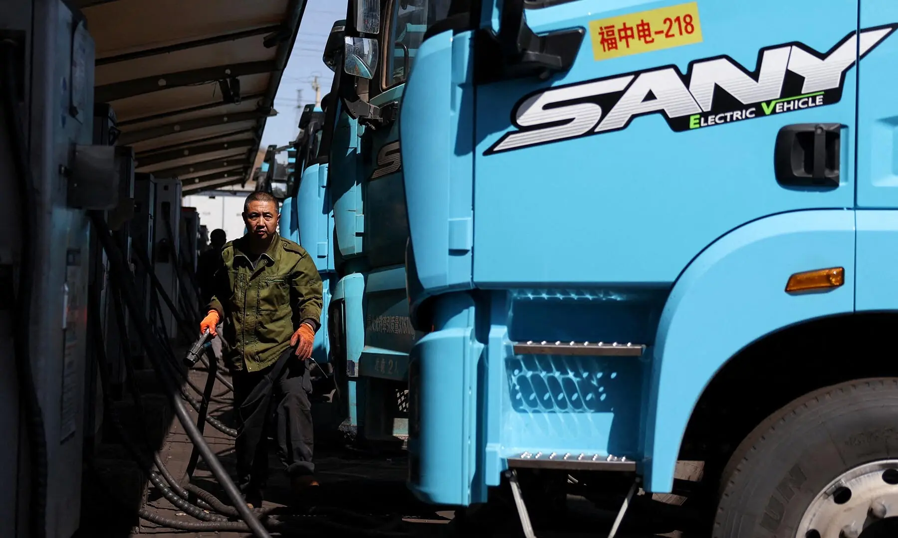 A driver uses a charging station to charge a Sany heavy electric truck at a fleet depot equipped with an electric truck charger, in Tangshan, Hebei province, China on April 1, 2026. &mdash; Reuters/File