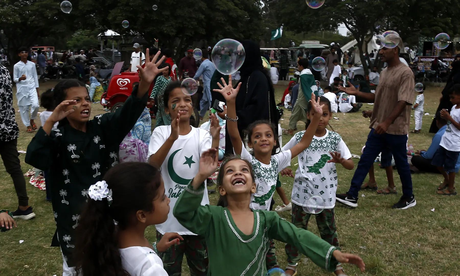 Children are seen playing with bubbles during Independence Day celebrations at Frere Hall in Karachi on Aug 14, 2026. — White Star
