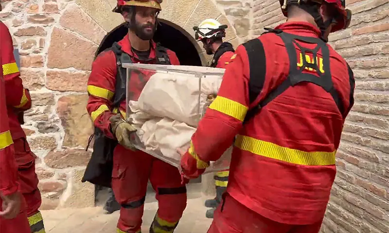 FIREFIGHTERS take away historical properties from a monastery in Spain’s south-western province of Aragon.—AFP FIREFIGHTERS take away historical properties from a monastery in Spain’s south-western province of Aragon.—AFP