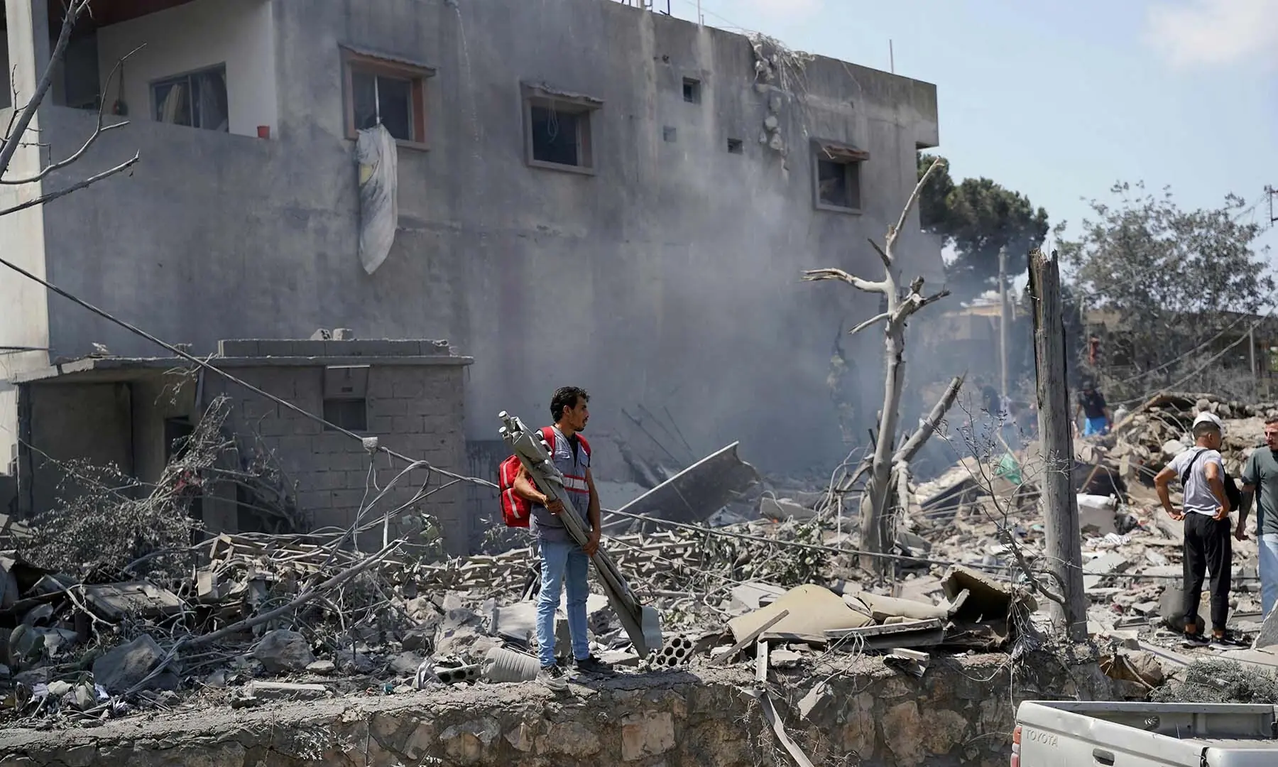 A man looks on as first aid responders and residents search to the site of an Israeli airstrike that targeted a neighborhood in the southern Lebanese village of Deir al-Zahrani on August 15 2026. &mdash; AFP