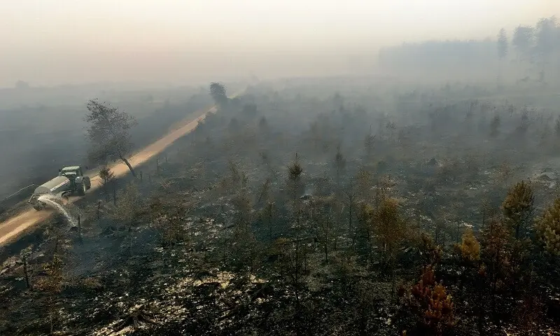 A drone view shows a farmer using his tractor to spray burnt fields and forests during a wildfire burning near Waimes, in the High Fens (Hautes Fagnes) region, Belgium August 16, 2026. — Reuters A drone view shows a farmer using his tractor to spray burnt fields and forests during a wildfire burning near Waimes, in the High Fens (Hautes Fagnes) region, Belgium August 16, 2026. — Reuters