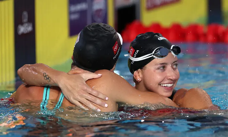 KATE Douglass (R) of the US celebrates after breaking the women’s 50m freestyle world record during the Pan Pacific Swimming Championships at the William Woollett Jr. Aquatics Center.—AFP KATE Douglass (R) of the US celebrates after breaking the women’s 50m freestyle world record during the Pan Pacific Swimming Championships at the William Woollett Jr. Aquatics Center.—AFP