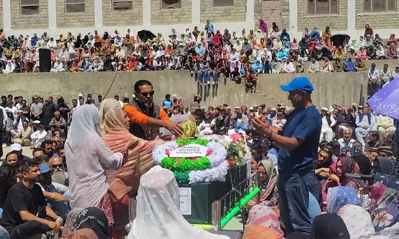 People gathered at Aliabad College Ground in Hunza to participate in the last rites of Sohail Sakhi on Sunday. &mdash; Dawn