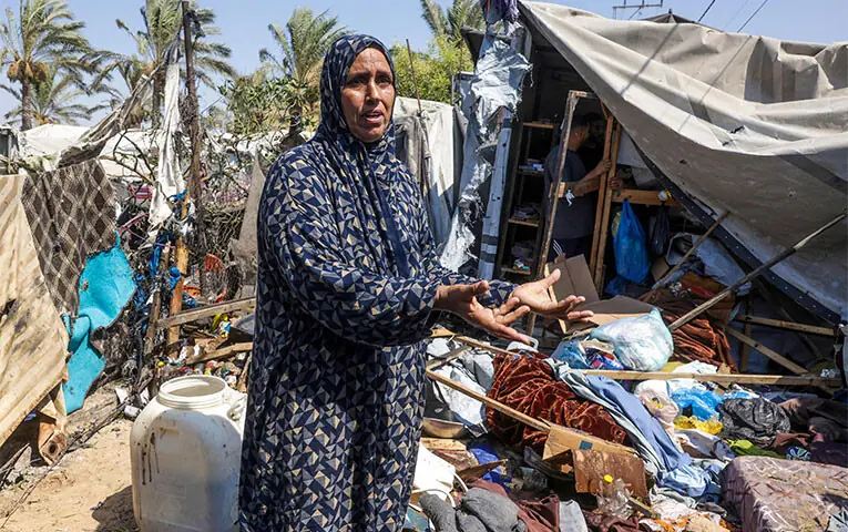 A DISPLACED Palestinian woman stands amid the remains of her tent after an Israeli strike in Khan Yunis, in the southern Gaza Strip.—AFP A DISPLACED Palestinian woman stands amid the remains of her tent after an Israeli strike in Khan Yunis, in the southern Gaza Strip.—AFP